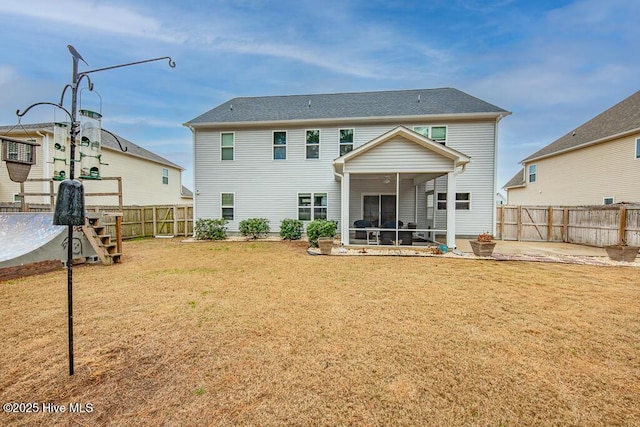 rear view of house featuring a yard, a patio area, and a sunroom