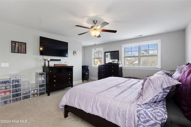 bedroom featuring light colored carpet and ceiling fan