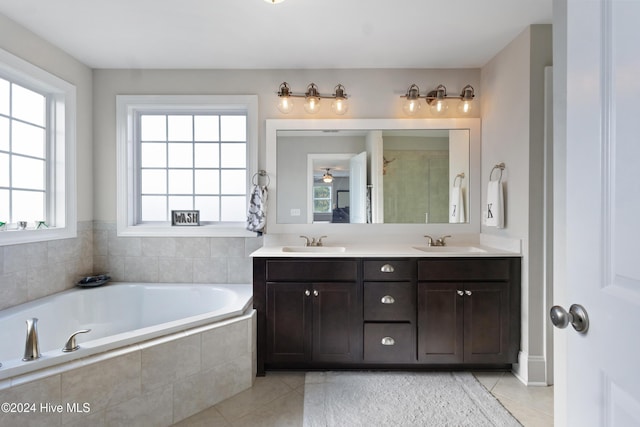 bathroom with vanity, tile patterned floors, and tiled tub