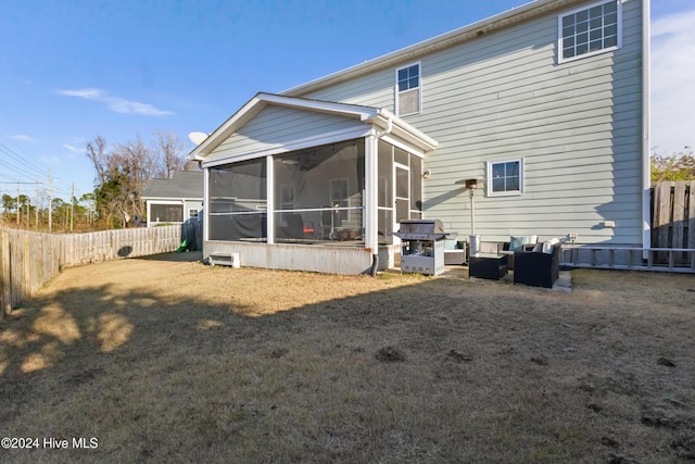 back of property with a sunroom