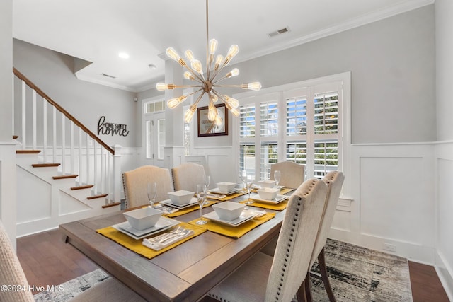 dining space featuring a notable chandelier, dark hardwood / wood-style floors, and ornamental molding