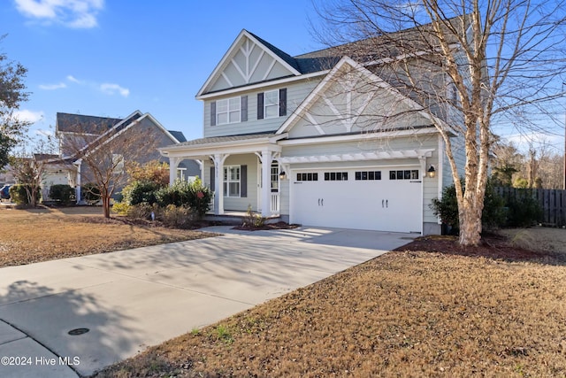 front facade featuring covered porch and a garage