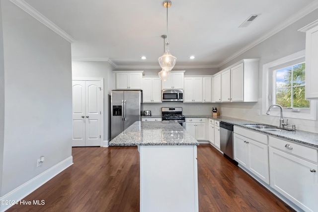 kitchen featuring a center island, stainless steel appliances, white cabinetry, and sink