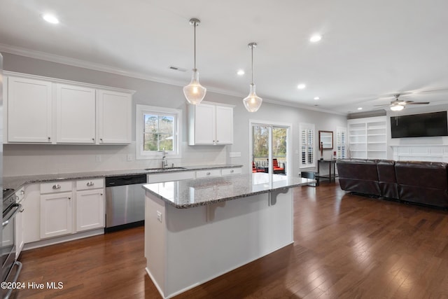 kitchen with dishwasher, a kitchen bar, white cabinetry, and hanging light fixtures