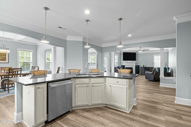 kitchen with a center island with sink, ceiling fan, sink, white cabinetry, and stainless steel dishwasher