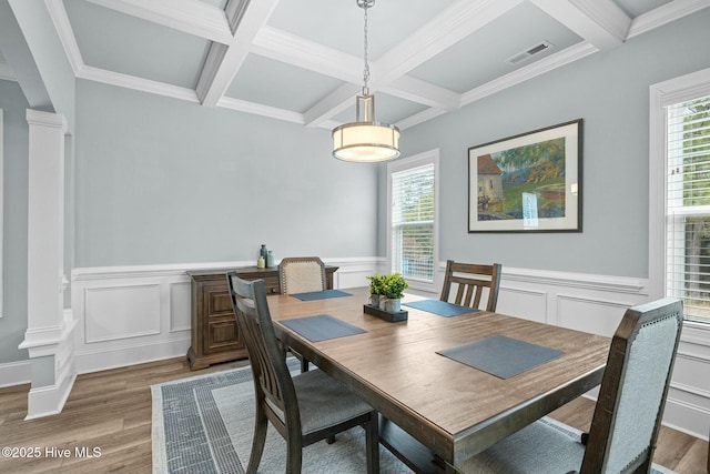 dining room with beam ceiling, coffered ceiling, plenty of natural light, and hardwood / wood-style flooring