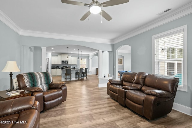 living room with ceiling fan, light hardwood / wood-style floors, and ornamental molding