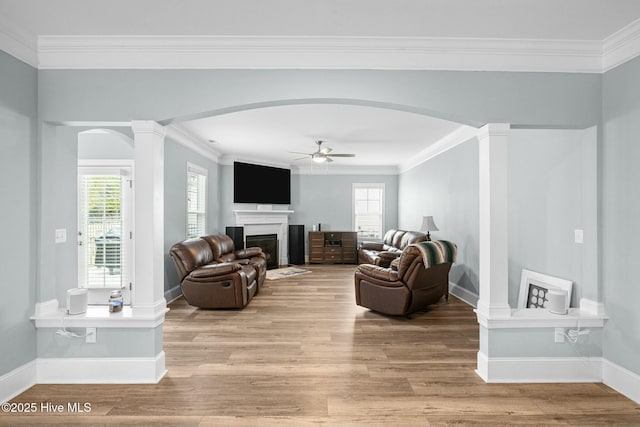 living room with ornamental molding, ceiling fan, light hardwood / wood-style floors, and ornate columns