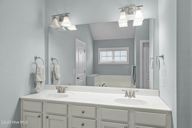 bathroom with a bathing tub, vaulted ceiling, and vanity