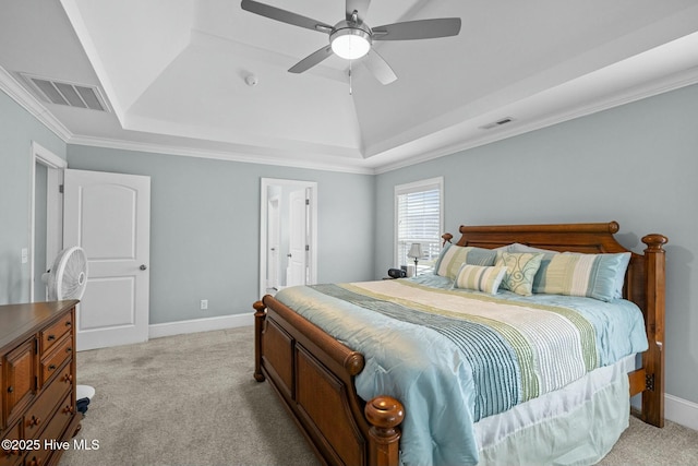 carpeted bedroom with a raised ceiling, ceiling fan, and ornamental molding