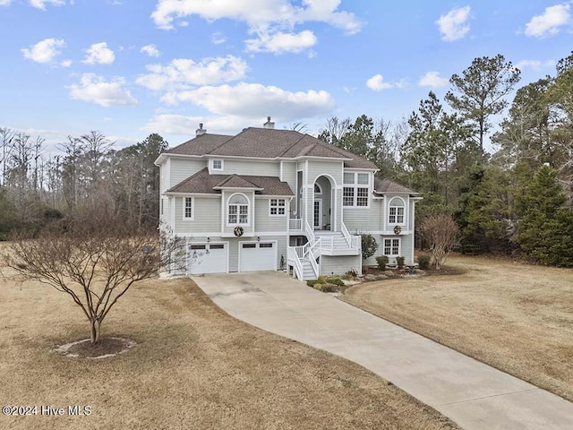 raised ranch featuring a front yard and a garage