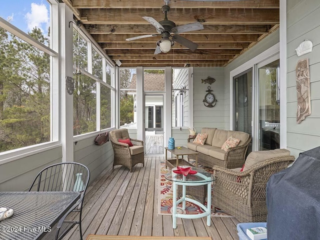 sunroom featuring ceiling fan