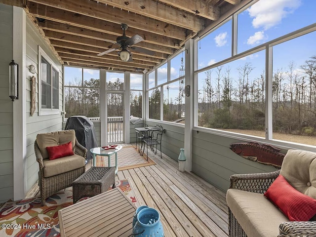 sunroom / solarium featuring ceiling fan