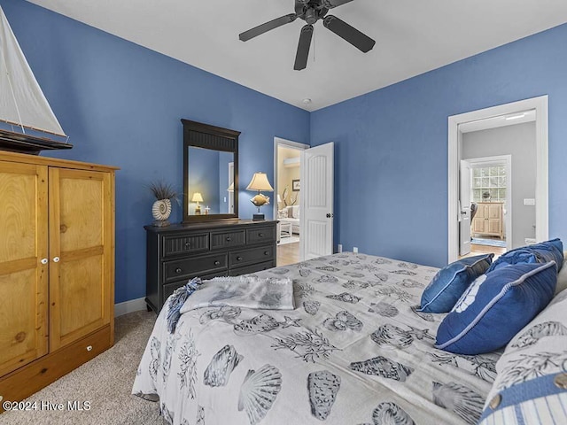 bedroom featuring carpet, ceiling fan, and ensuite bathroom