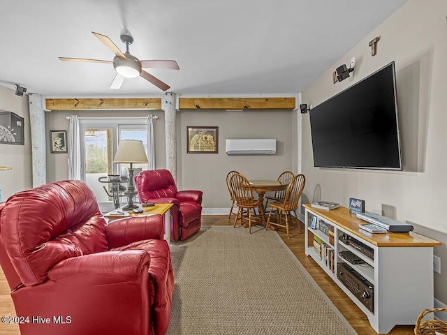 living room with hardwood / wood-style floors, an AC wall unit, and ceiling fan