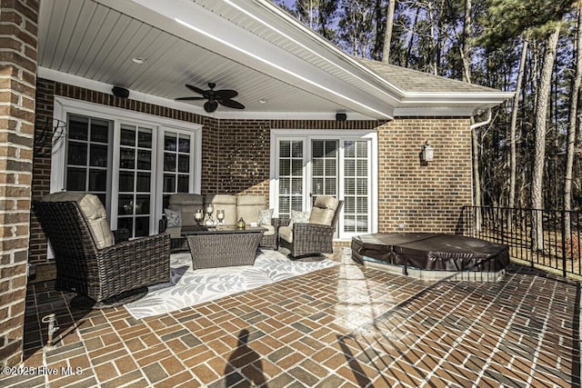 view of patio / terrace with an outdoor hangout area, ceiling fan, and a covered hot tub