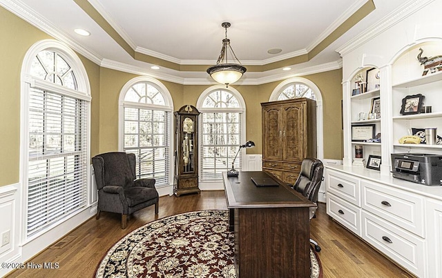 office featuring dark wood-type flooring, a tray ceiling, and ornamental molding