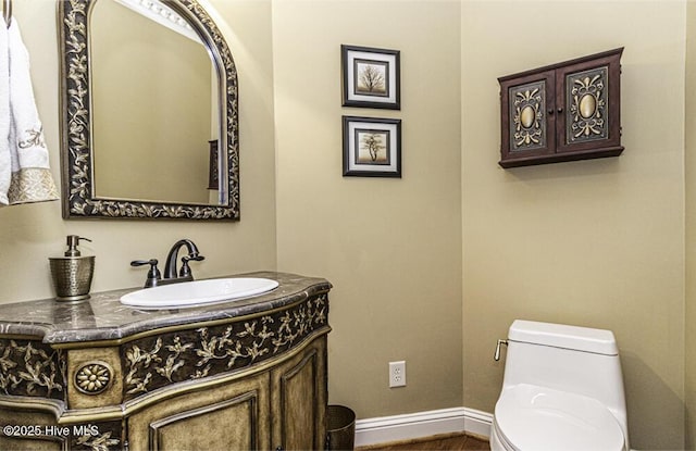 bathroom featuring toilet and vanity