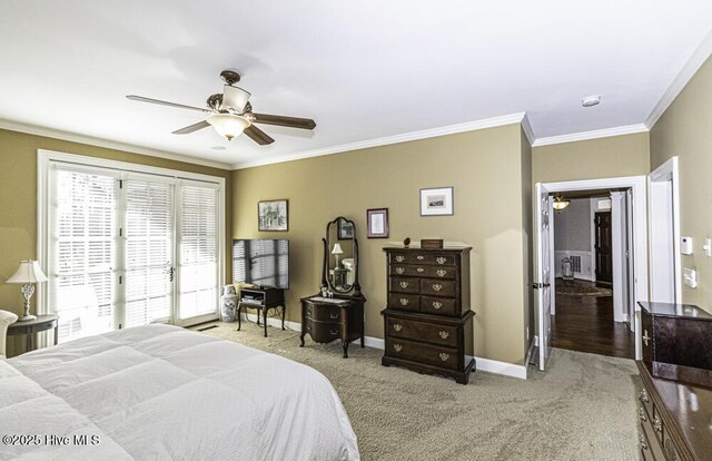 carpeted bedroom featuring ceiling fan and ornamental molding