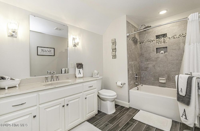 full bathroom featuring toilet, vanity, and shower / bath combo with shower curtain