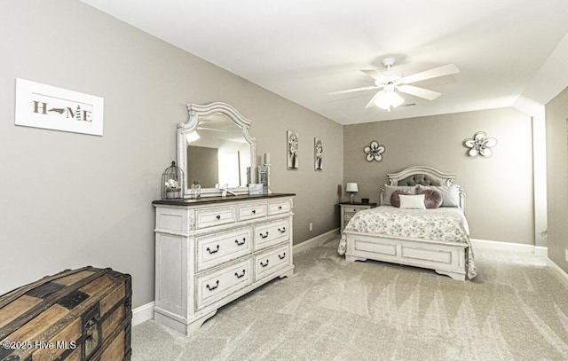 bedroom with ceiling fan, light carpet, and vaulted ceiling