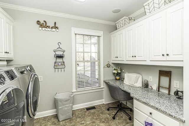 clothes washing area with crown molding, washing machine and clothes dryer, and cabinets