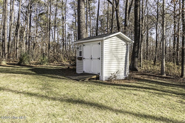 view of outbuilding featuring a yard