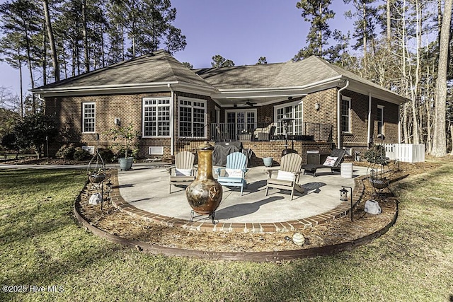 back of house featuring ceiling fan, a patio area, and a yard