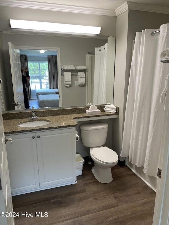 full bathroom with wood-type flooring, toilet, shower / bathtub combination with curtain, and crown molding