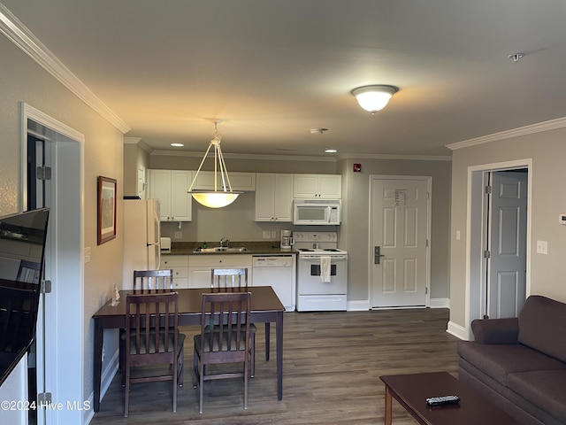 kitchen with ornamental molding, white appliances, pendant lighting, wood-type flooring, and white cabinetry