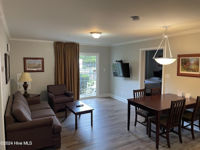 living room with hardwood / wood-style floors and ornamental molding