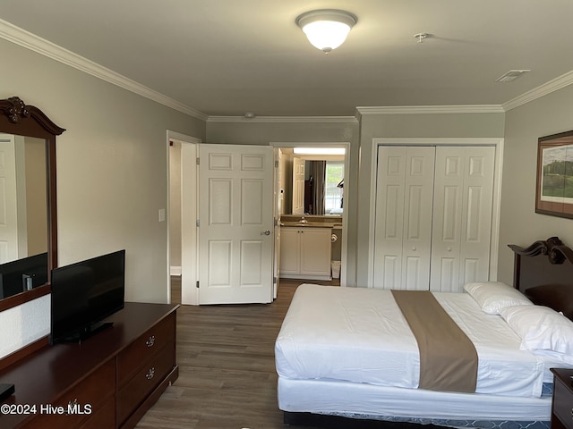 bedroom featuring ornamental molding, a closet, and dark wood-type flooring