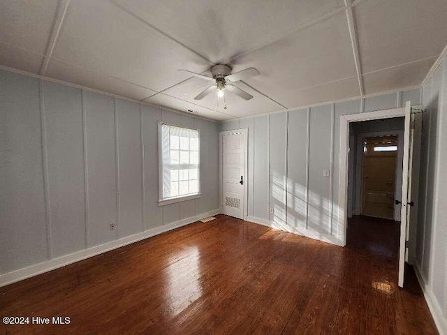 unfurnished room featuring ceiling fan and dark hardwood / wood-style flooring