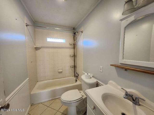 full bathroom with tile patterned floors, vanity, tiled shower / bath combo, crown molding, and toilet