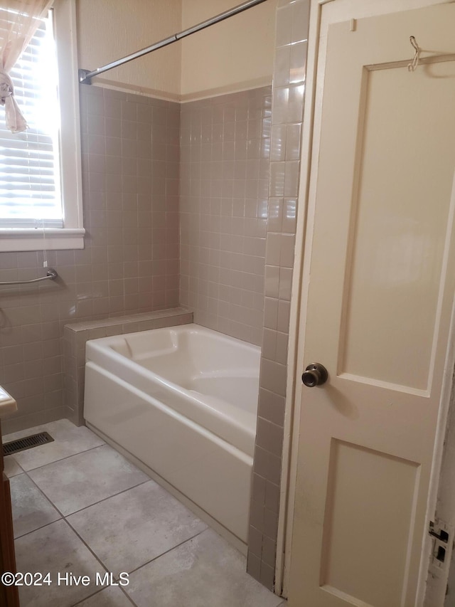 bathroom featuring tile patterned floors and tiled shower / bath combo