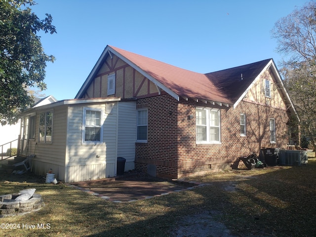 view of home's exterior featuring a yard and central AC