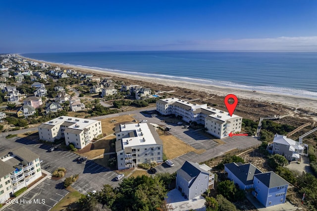 birds eye view of property featuring a beach view and a water view