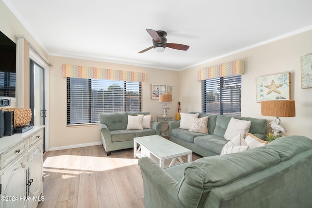 living room featuring plenty of natural light, light wood-type flooring, and crown molding