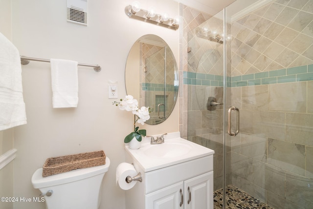 bathroom featuring vanity, ornamental molding, an enclosed shower, and toilet