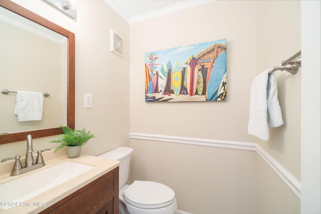 bathroom featuring vanity, toilet, and ornamental molding