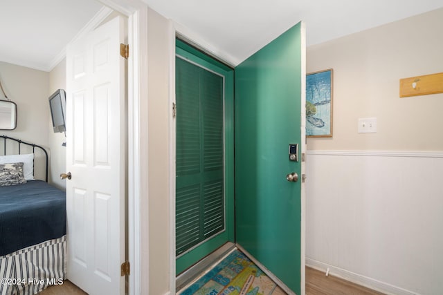 foyer entrance featuring hardwood / wood-style flooring and ornamental molding