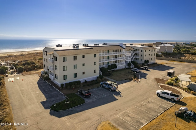 drone / aerial view featuring a water view and a beach view