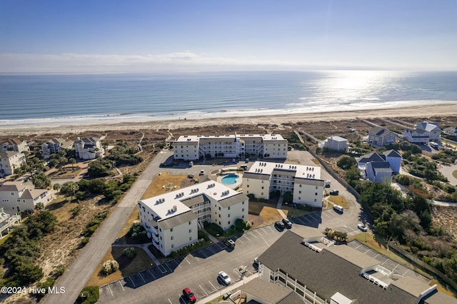 drone / aerial view with a water view and a beach view