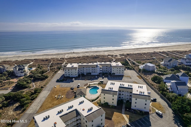 birds eye view of property featuring a water view and a beach view