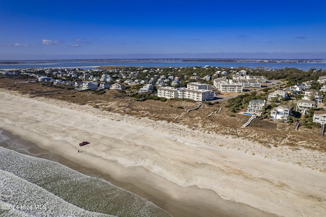 drone / aerial view with a water view and a view of the beach