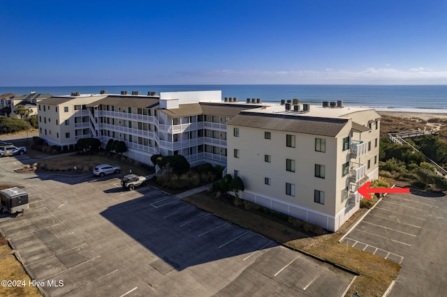 aerial view featuring a view of the beach and a water view