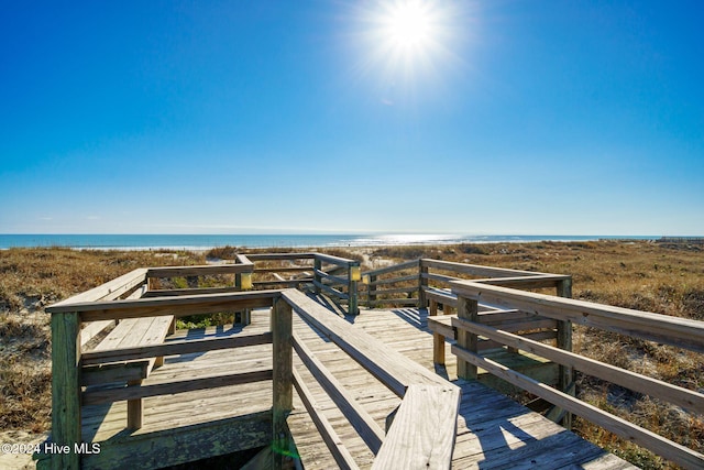 view of property's community with a deck with water view