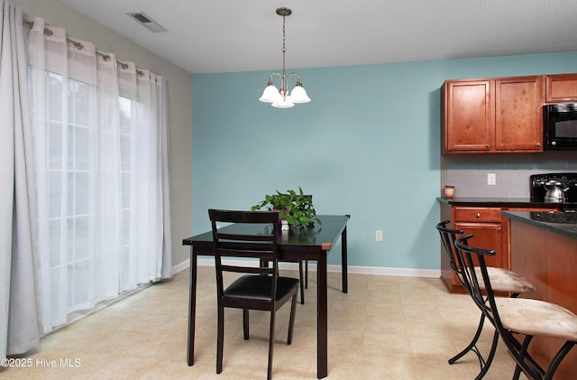 dining space with a chandelier