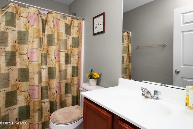 bathroom featuring vanity, a shower with curtain, a textured ceiling, and toilet