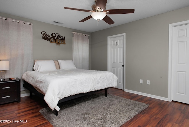 bedroom featuring ceiling fan and dark wood-type flooring